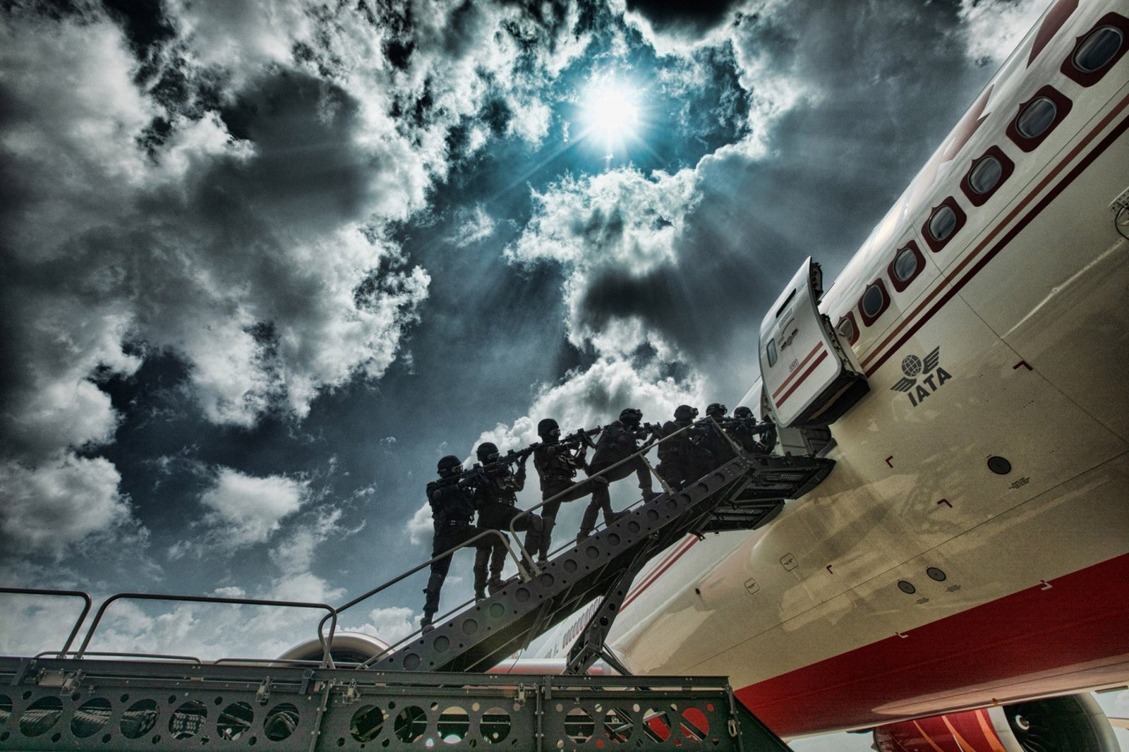 A counter-hijack team approaches an aircraft during a drill. The fuselage gives the photograph its scale.