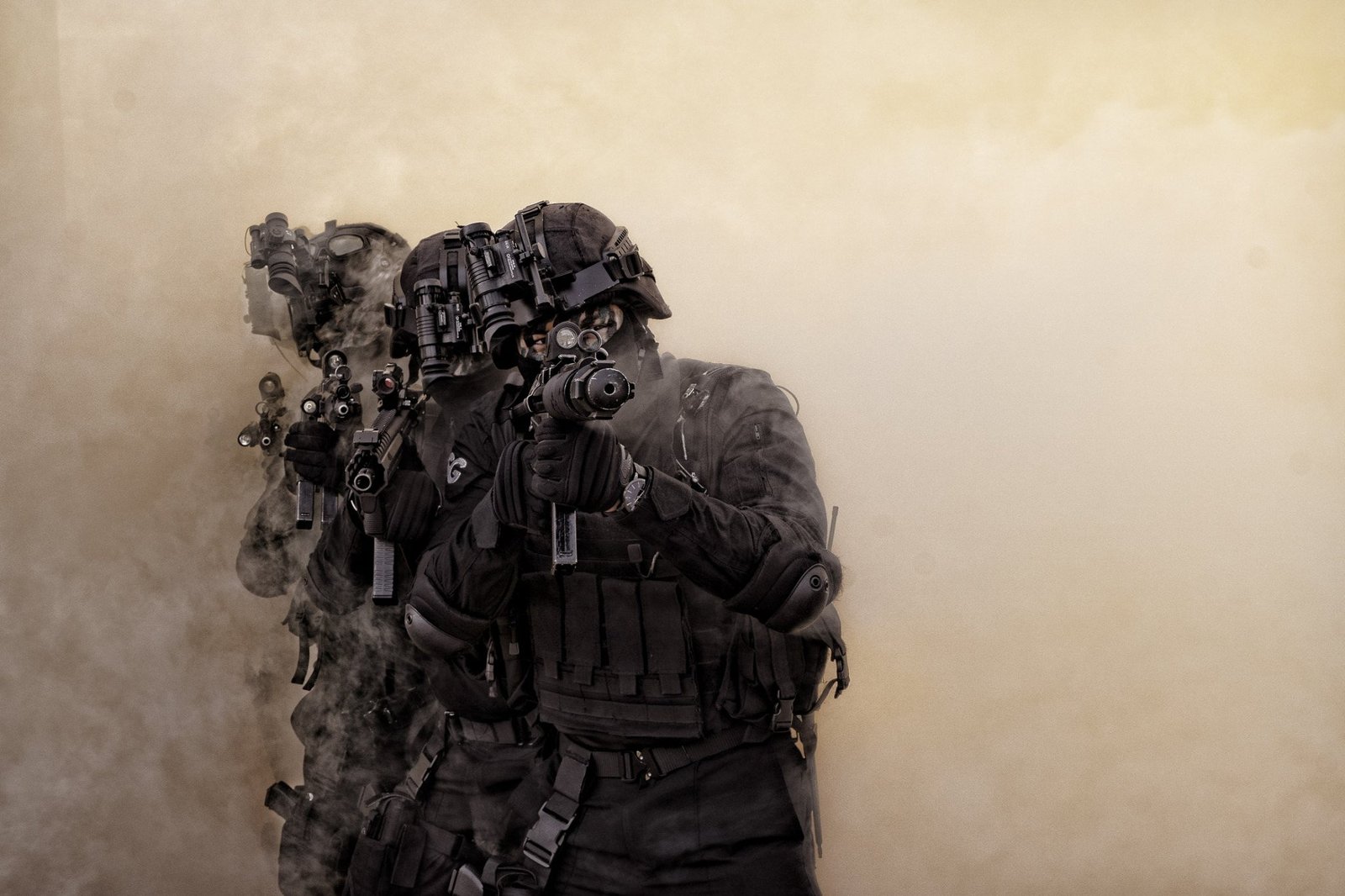 Masked NSG commandos in close formation during training, emerging through smoke.